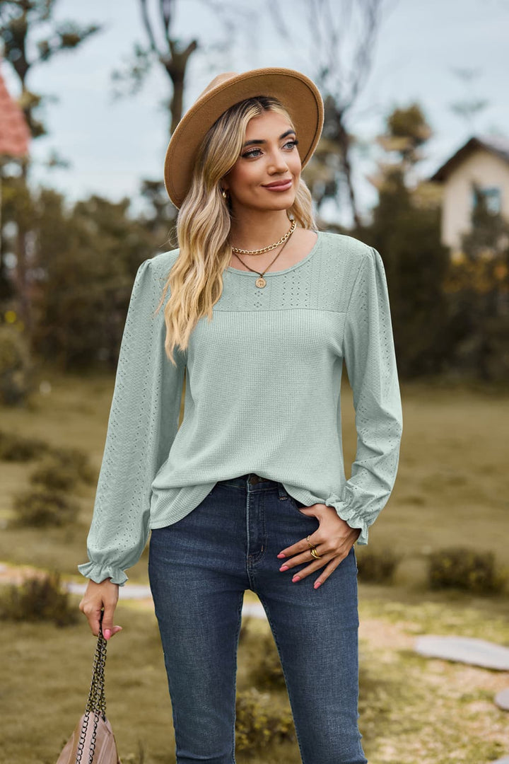 Eyelet knit puff sleeve blouse with round neckline