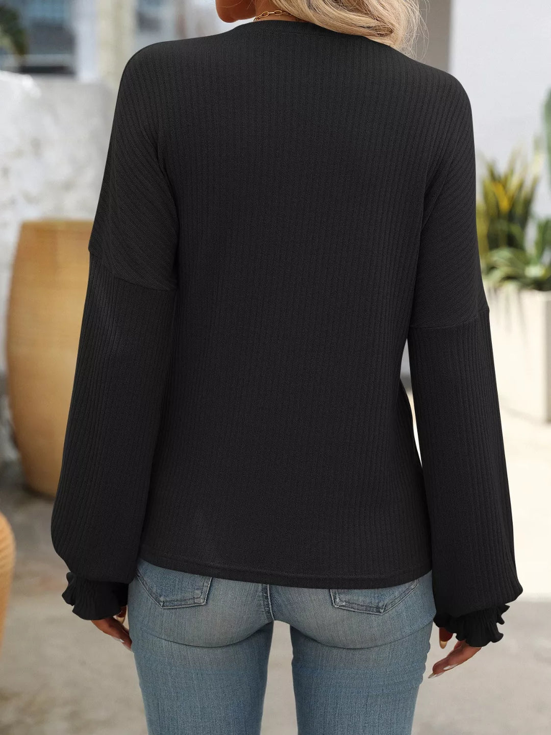 Ribbed knit crew neck top with ruffled smocked cuffs