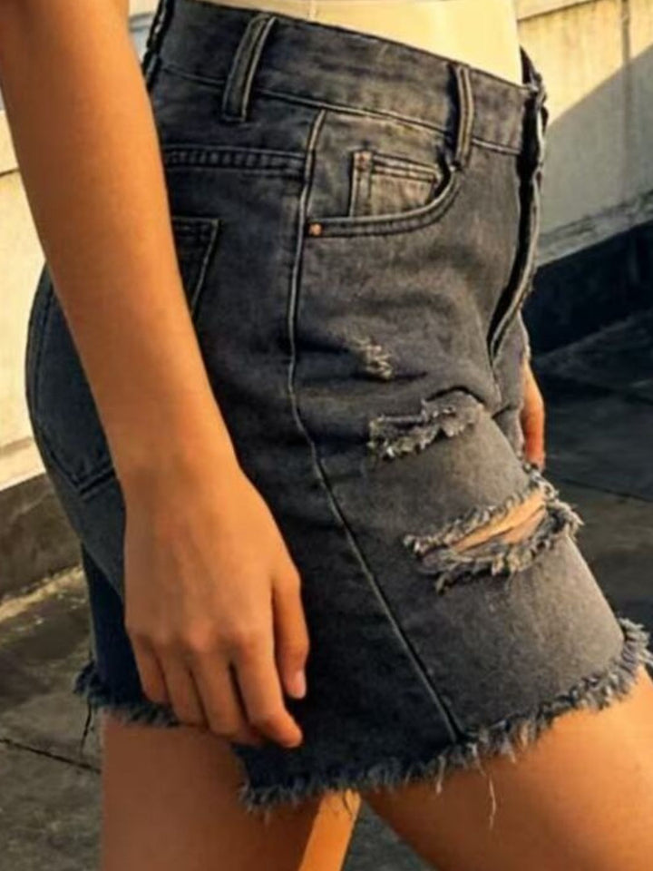 Distressed mid-thigh denim shorts with raw frayed hem