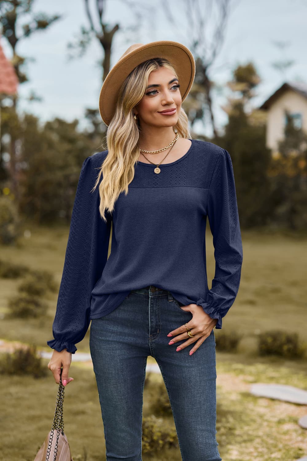 Eyelet knit puff sleeve blouse with round neckline