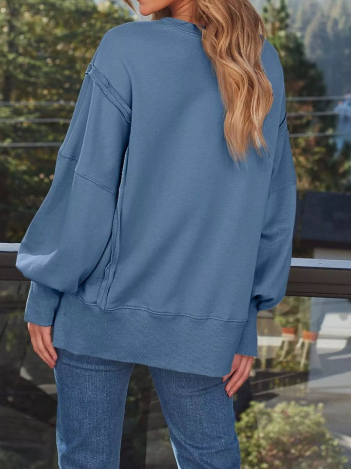 Oversized side-slit sweatshirt with exposed seams