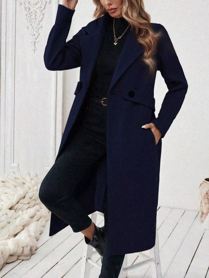Longline notch lapel coat with single-button waist tab