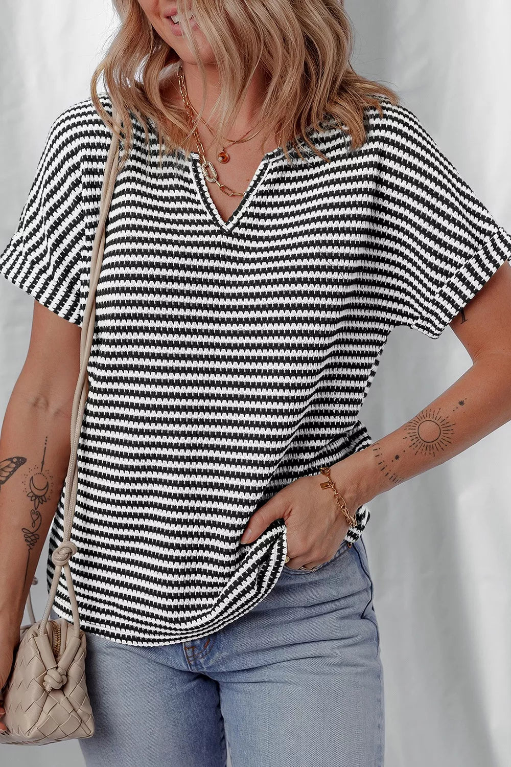 Stripe Striped textured knit top with notched V-neck and cuffed sleeves