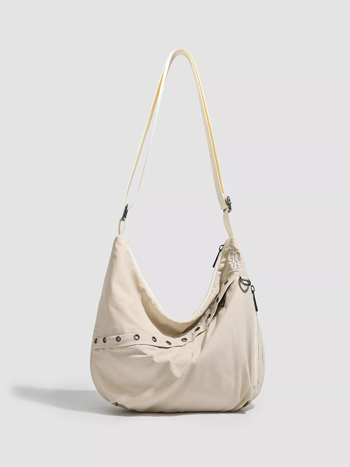Beige Grommet-studded nylon crossbody sling bag with zip pockets