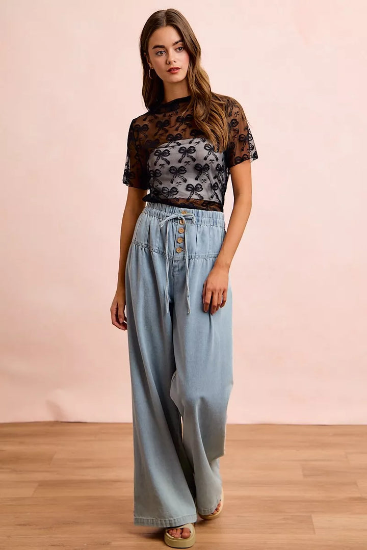 Sheer mesh mock-neck top with allover bow pattern