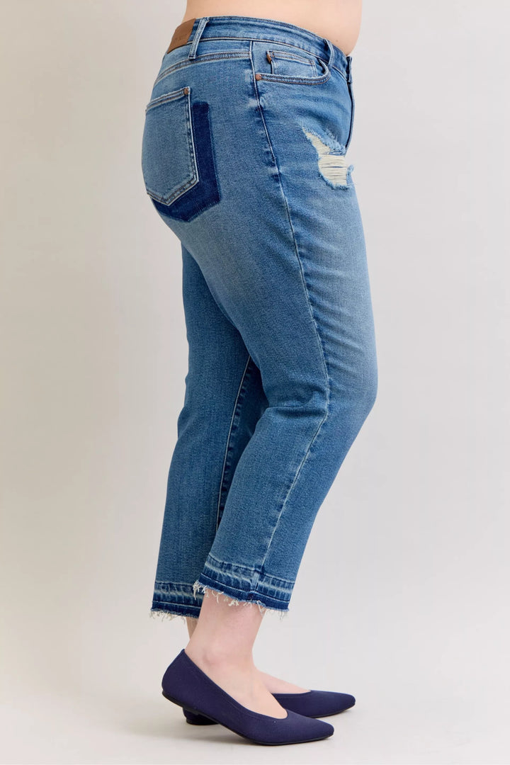 Distressed mid-rise boyfriend jeans with released raw hem
