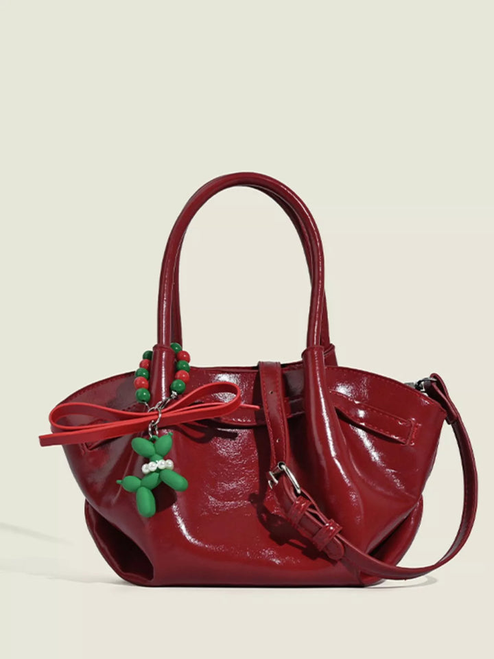 Glossy slouchy top handle crossbody bag with beaded charm