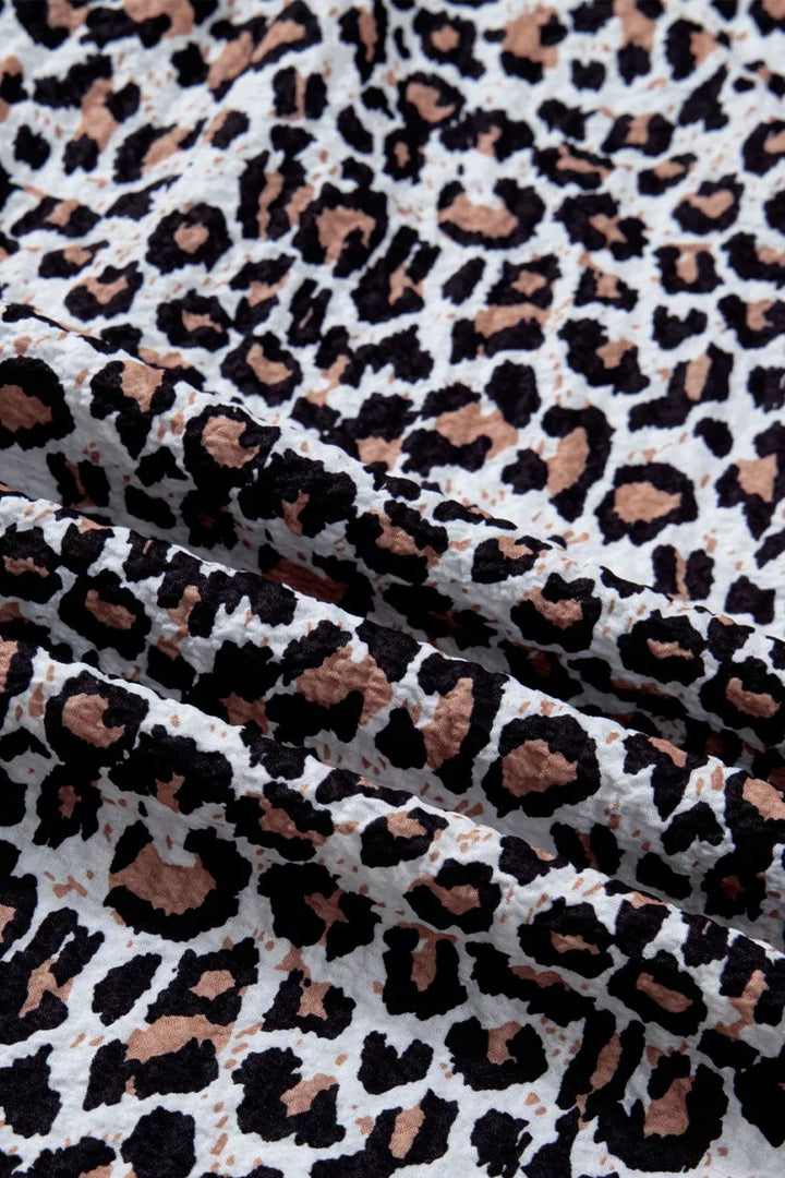 Leopard print short sleeve button-down with contrast ruffle trim