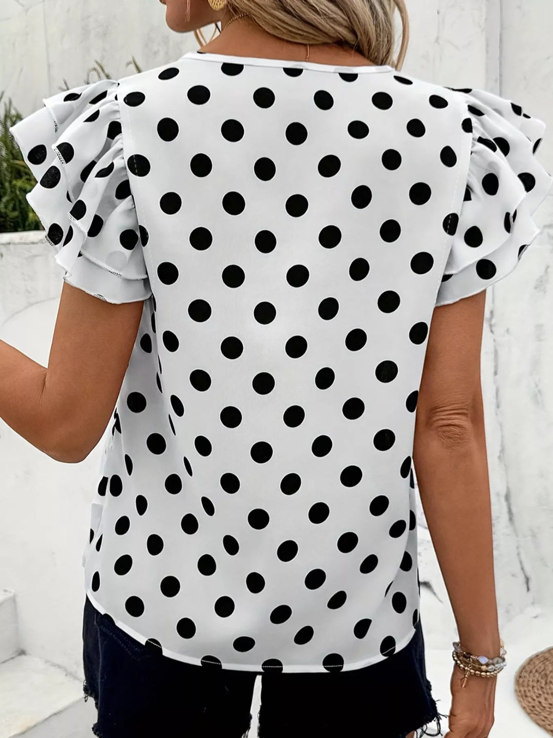 Polka dot blouse with tiered ruffle cap sleeves