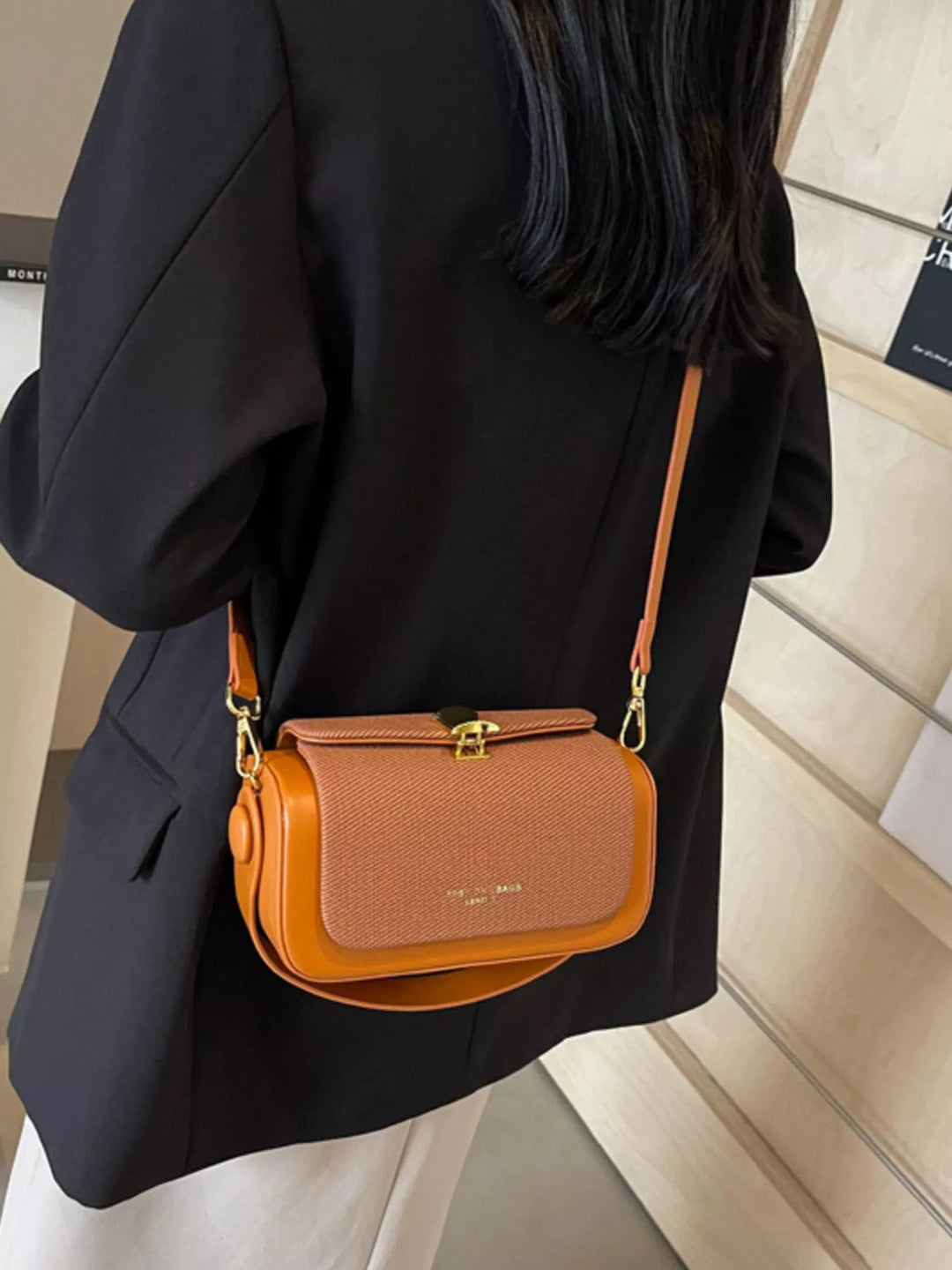 Structured boxy crossbody bag with gold clasp and top handle