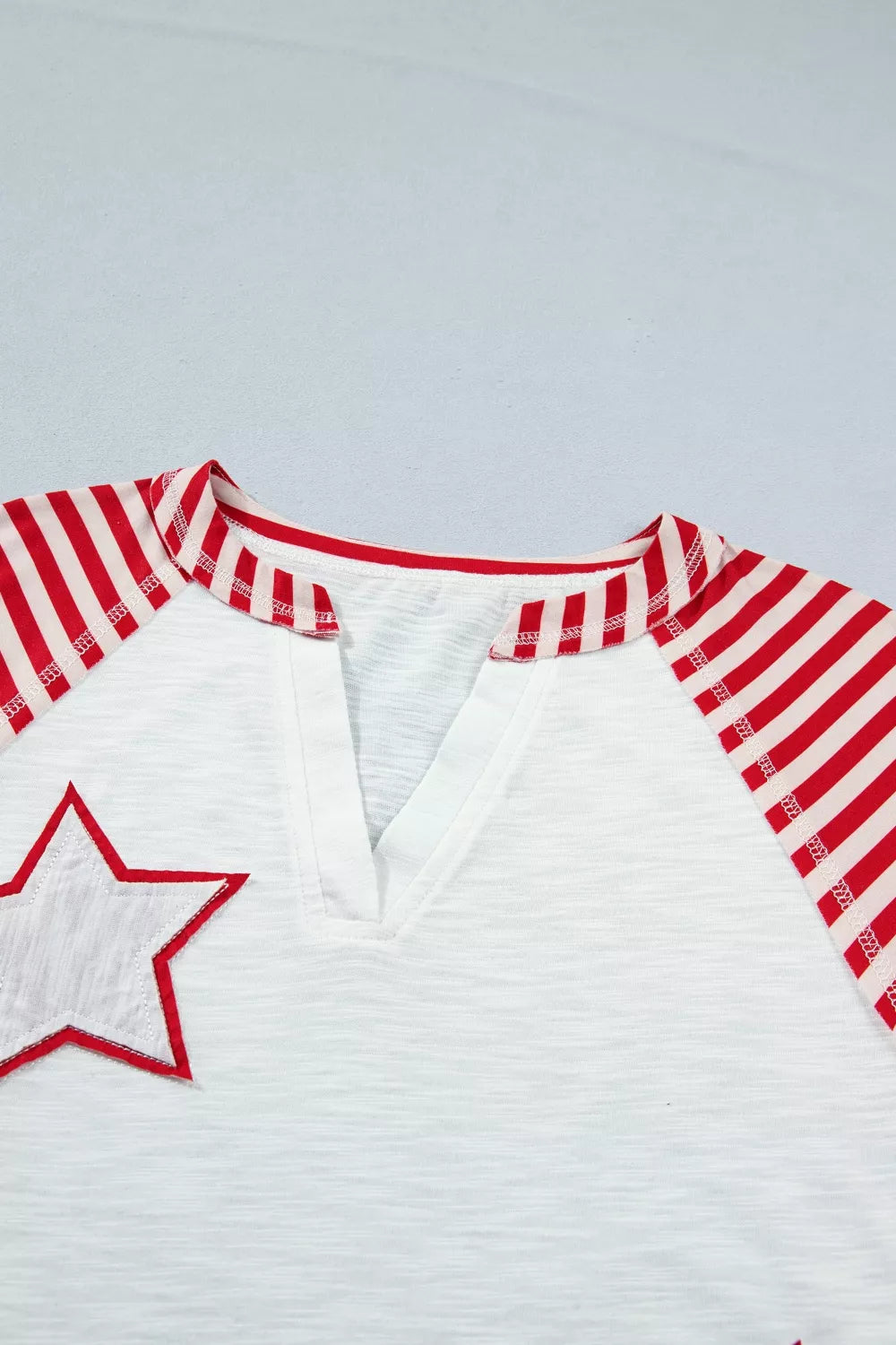 Star patch flag-inspired V-neck top with ruffle sleeves