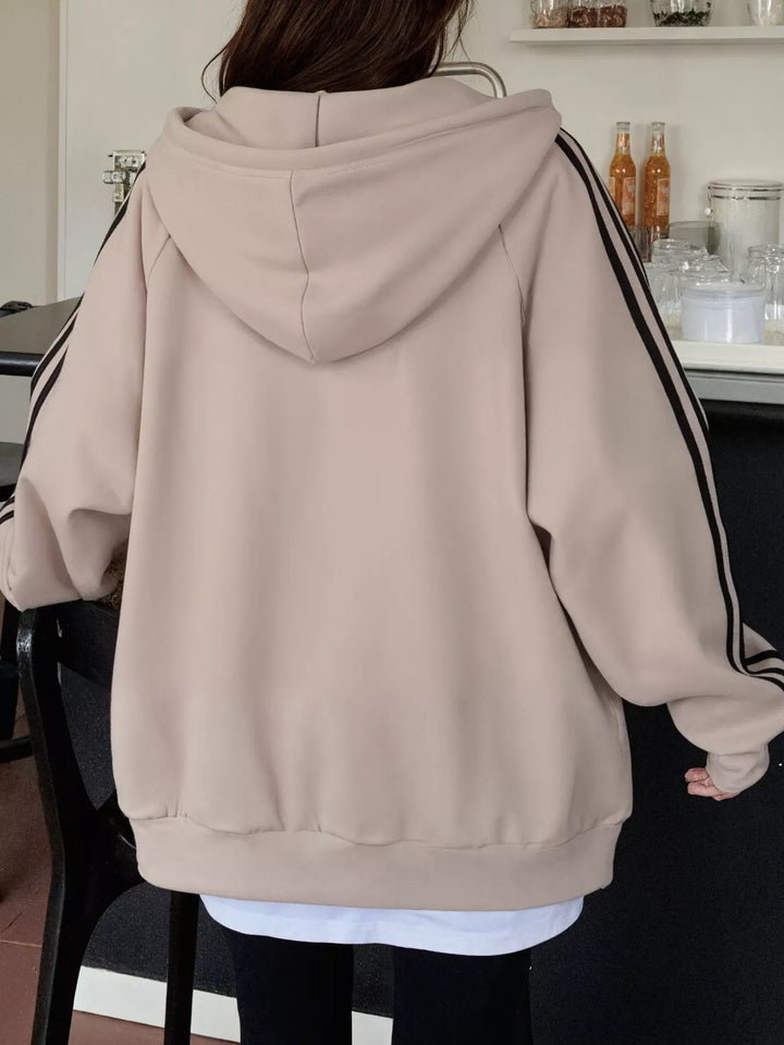 Oversized zip-up hoodie with striped sleeves and drawstring hood