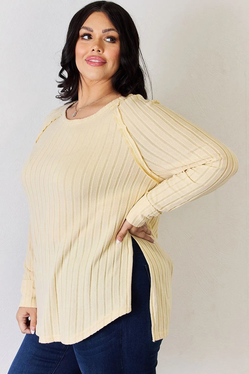 Ribbed knit round neck long sleeve top with side slits