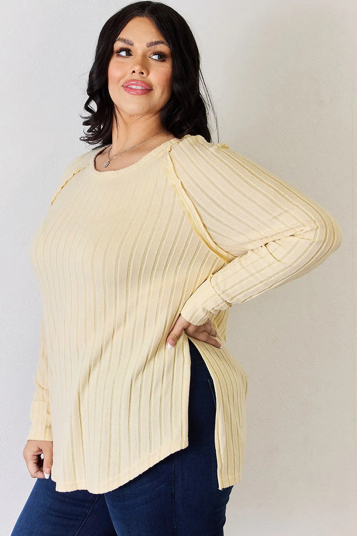 Ribbed knit round neck long sleeve top with side slits