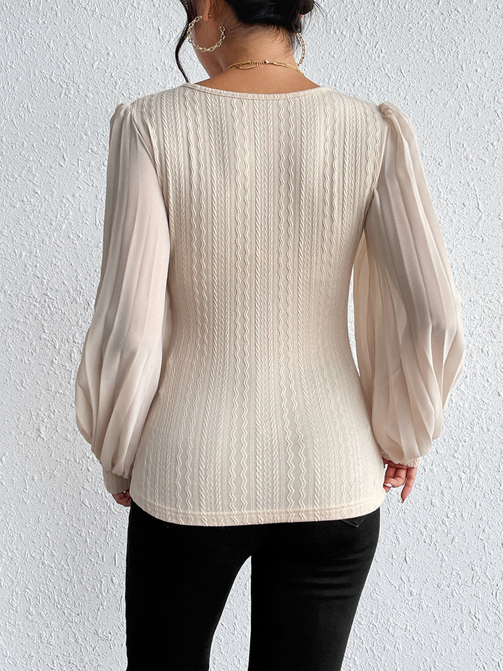Textured knit blouse with puff sleeves and round neck