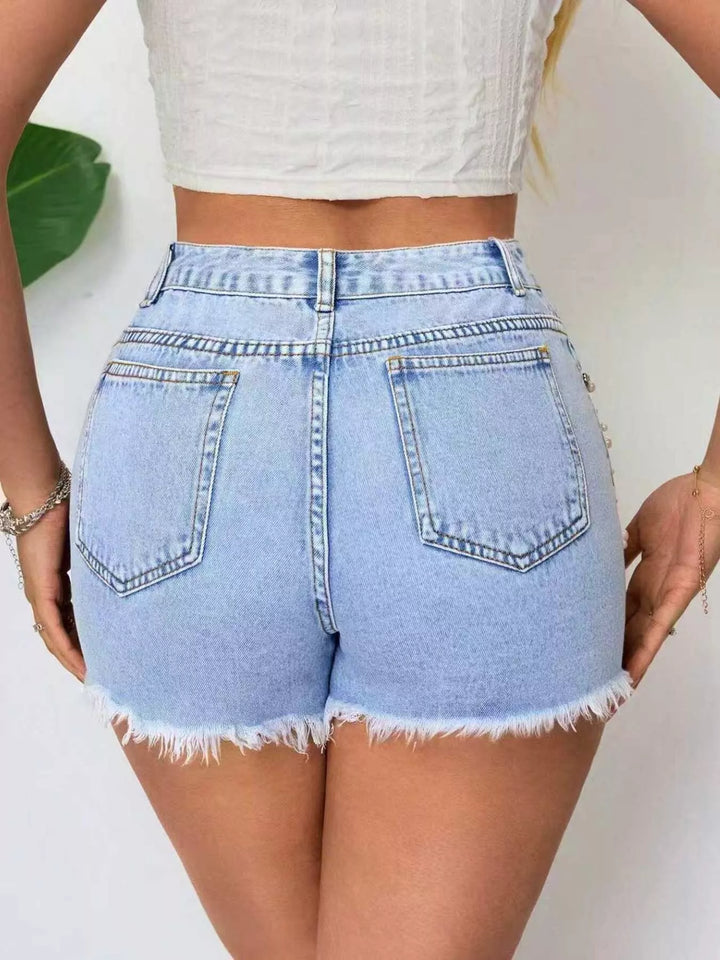 High-rise distressed denim shorts with raw hem