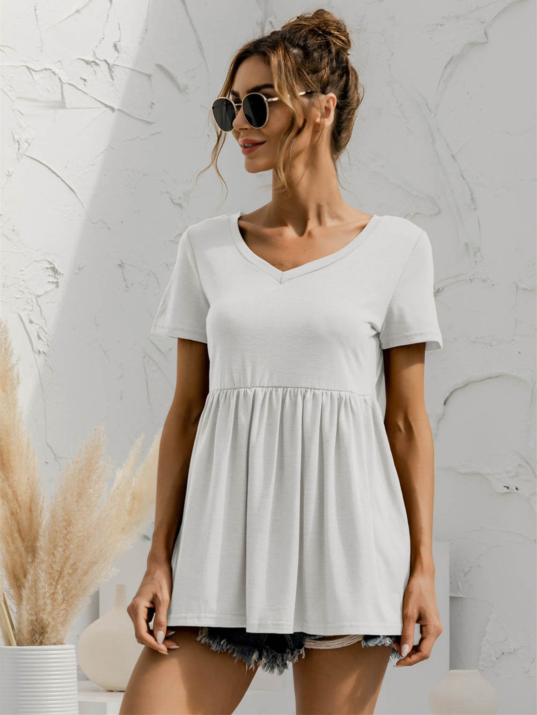 White V-neck babydoll top with short sleeves and empire waist