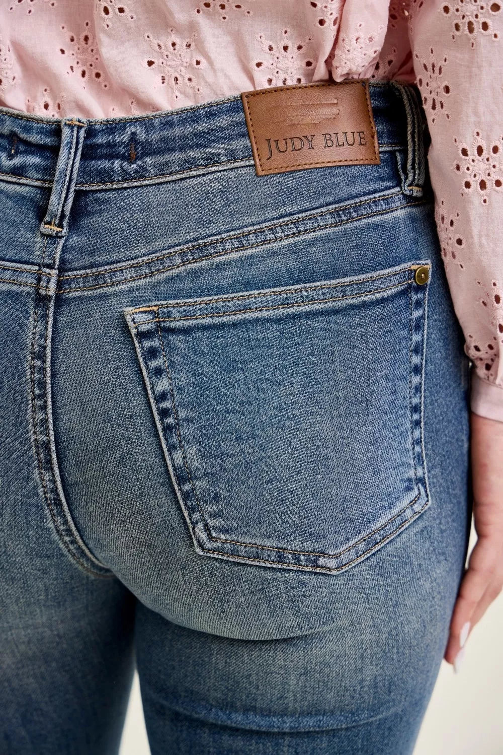 Judy Blue mid-rise flare jeans with front flap pockets and raw hem