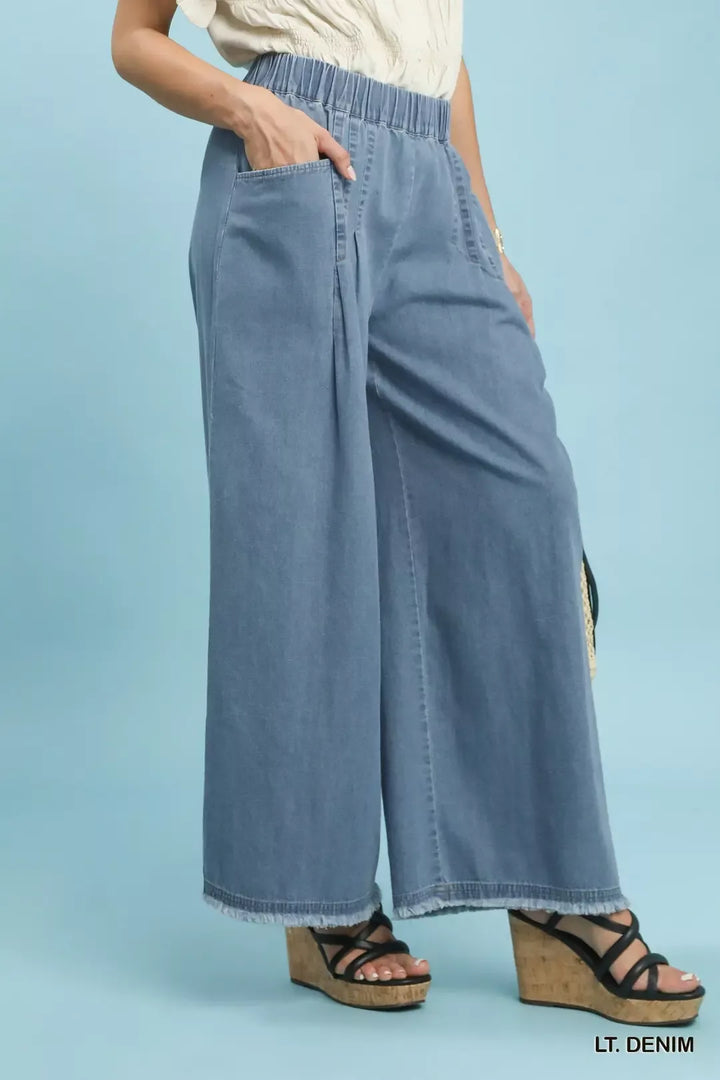 Stone washed wide-leg cotton pants with raw frayed hem