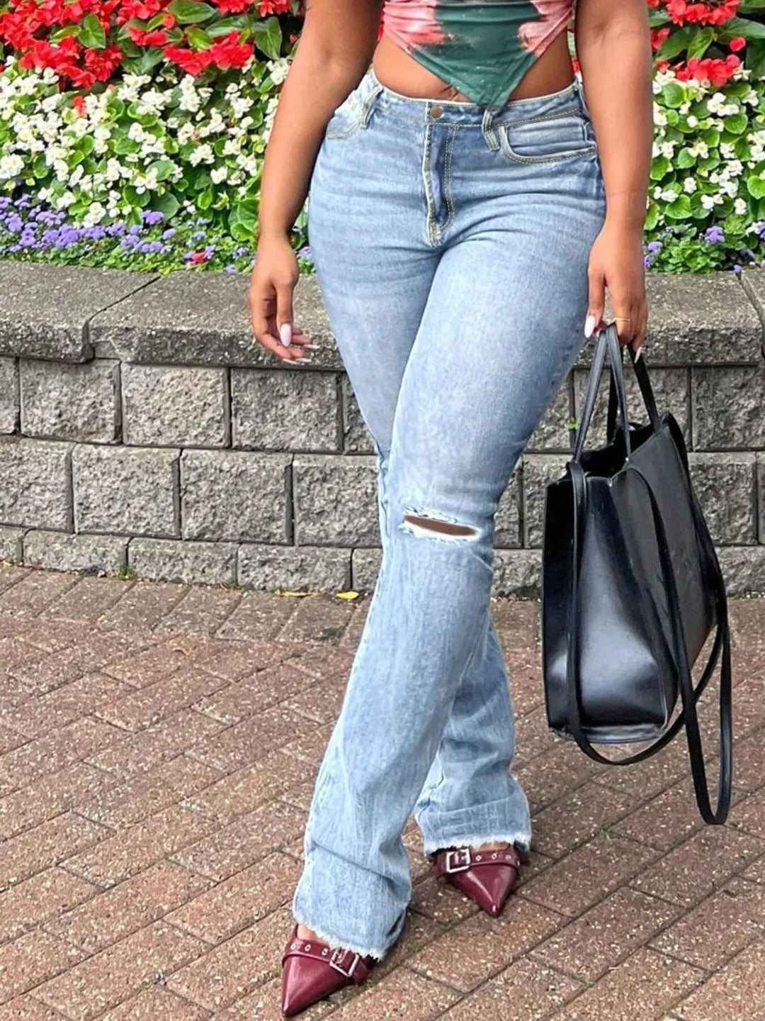 High-rise ripped knee flare jeans with raw hem