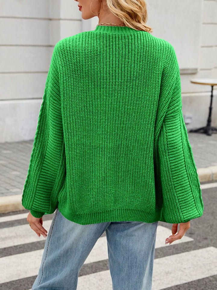 Cable knit button-front cardigan with drop shoulder sleeves