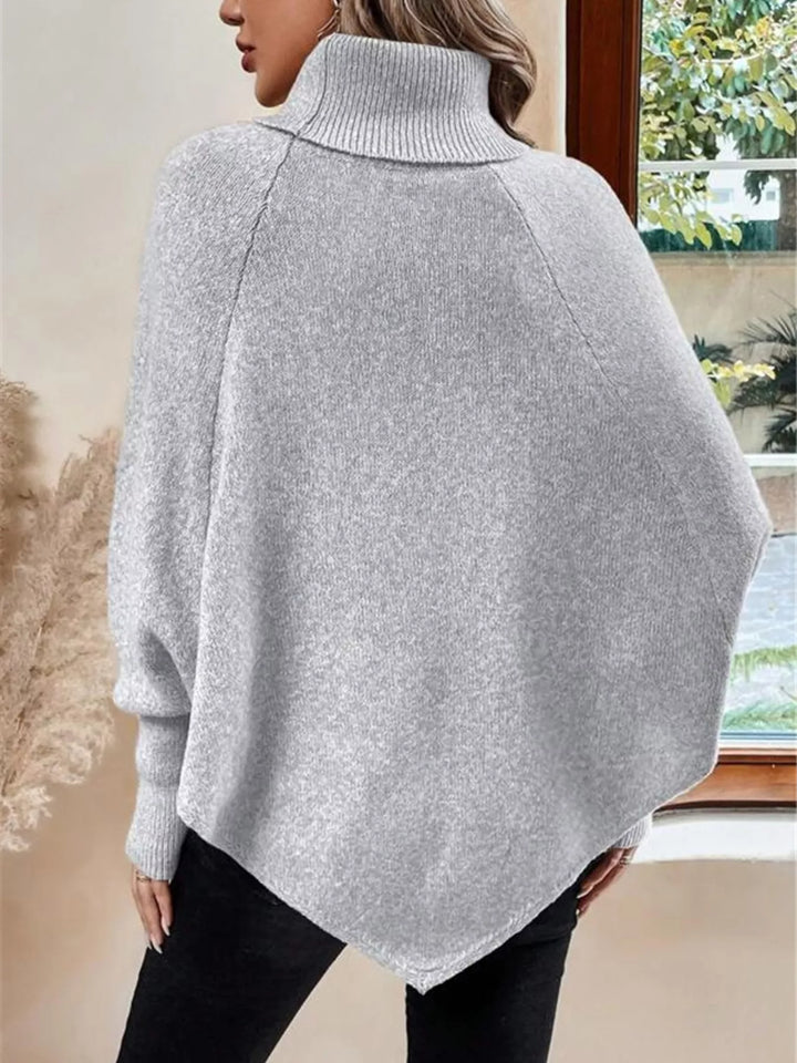 Cable knit turtleneck cape sweater with button shoulder