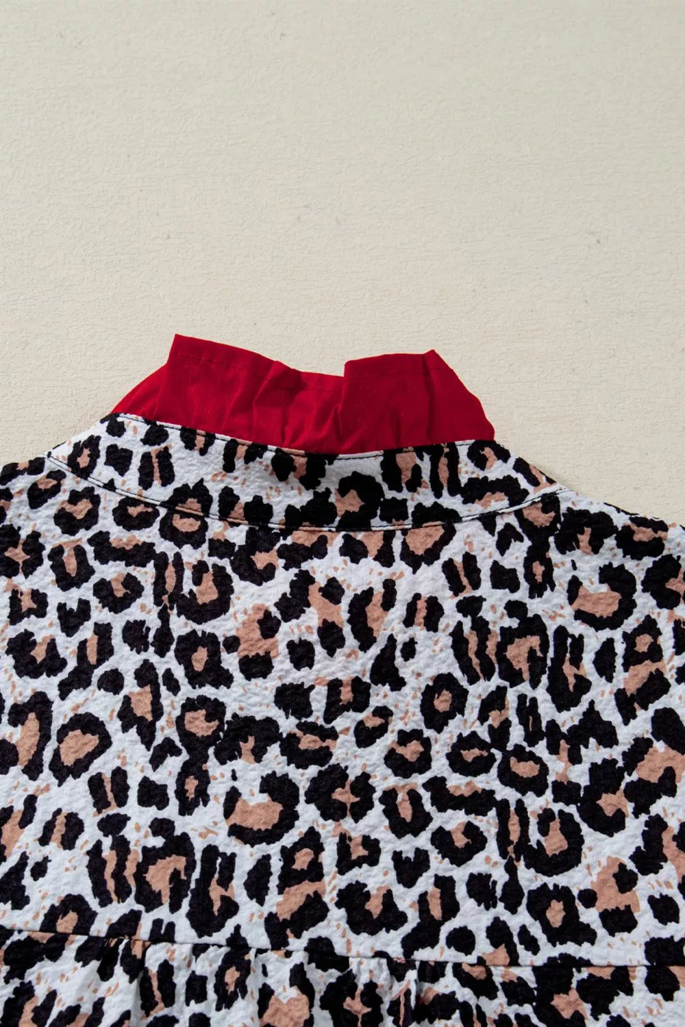 Leopard print short sleeve button-down with contrast ruffle trim
