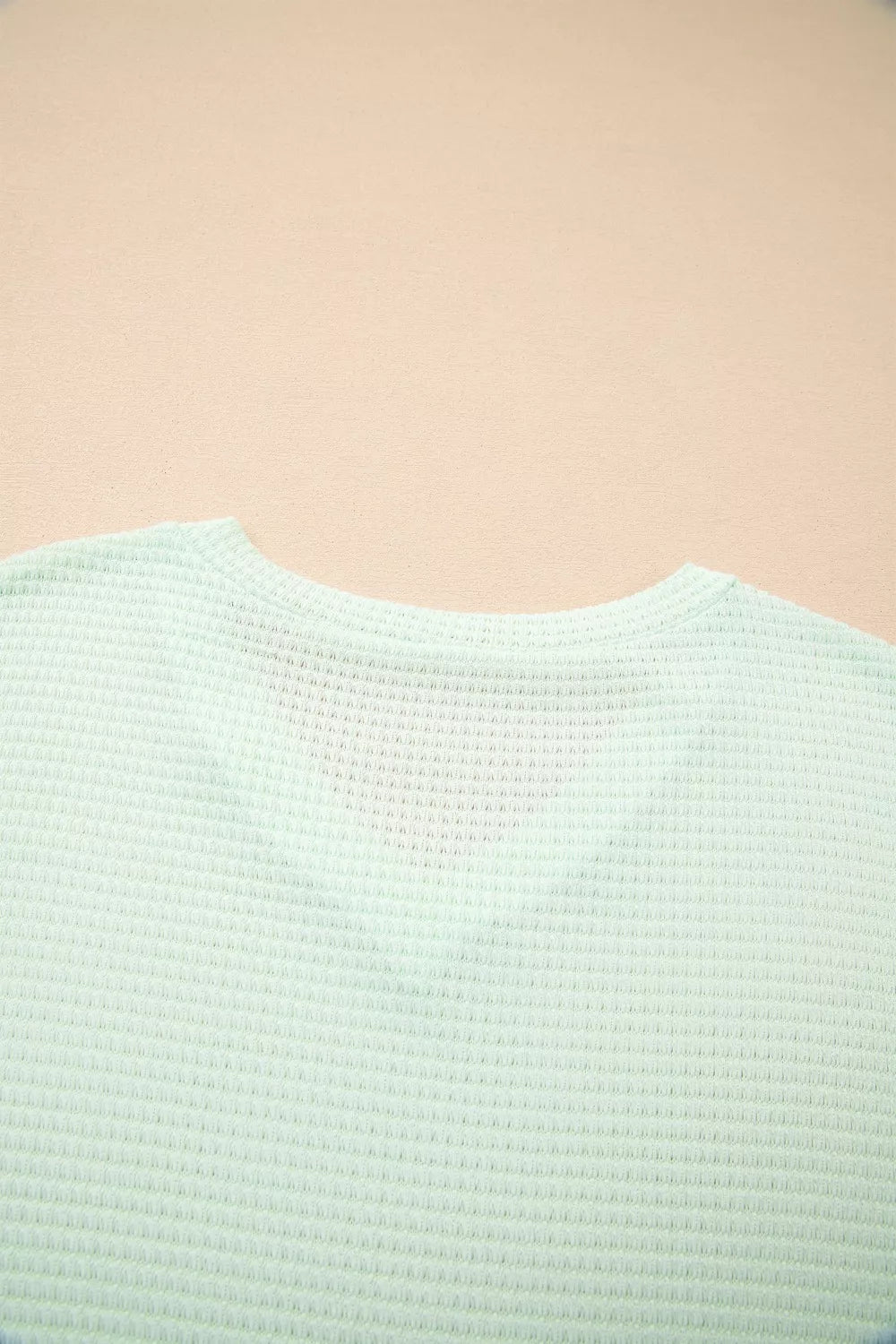 Plus size waffle knit V-neck top with cuffed short sleeves