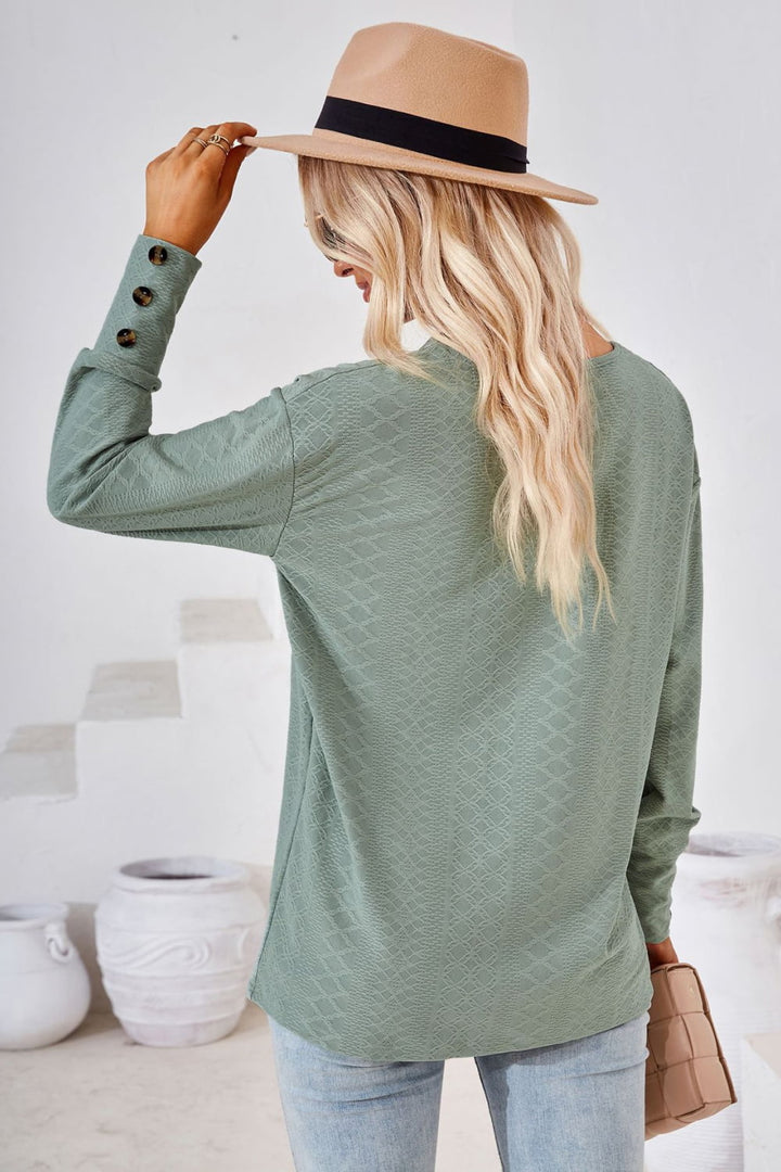 Textured knit V-neck long sleeve top with button cuffs