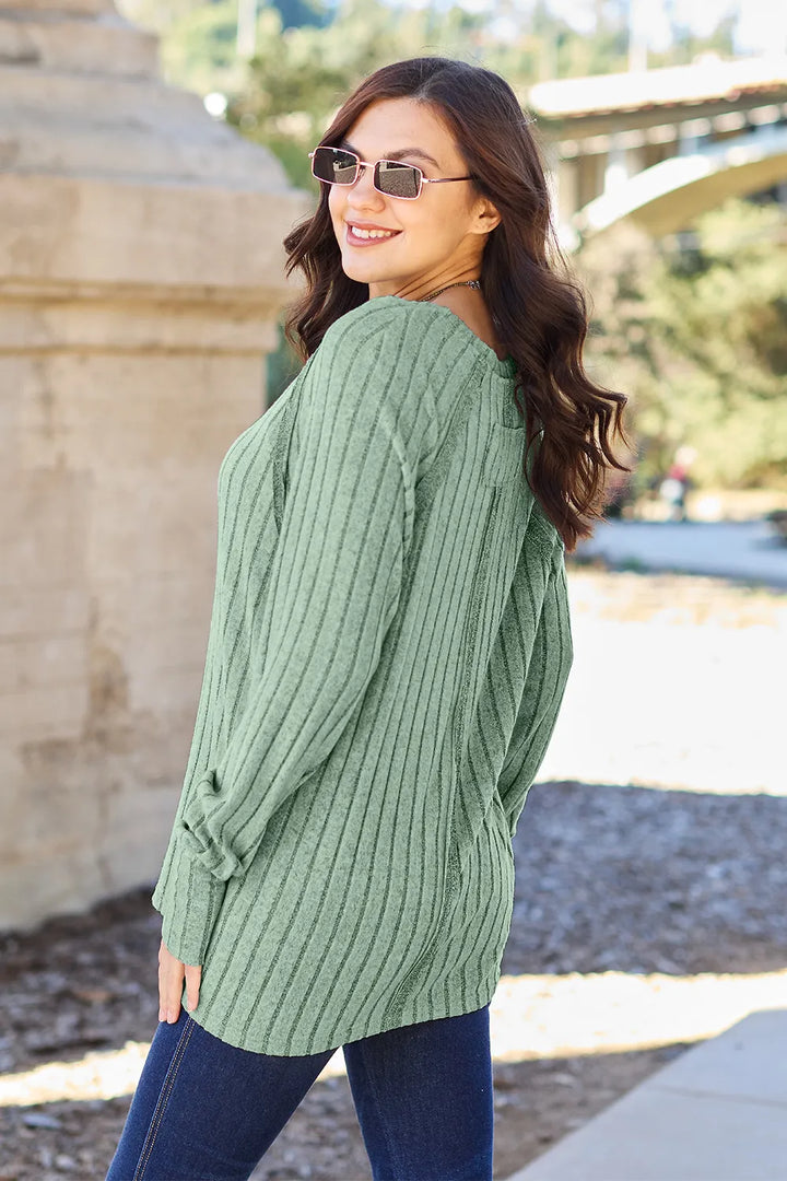 Ribbed knit round neck long sleeve top with curved hem