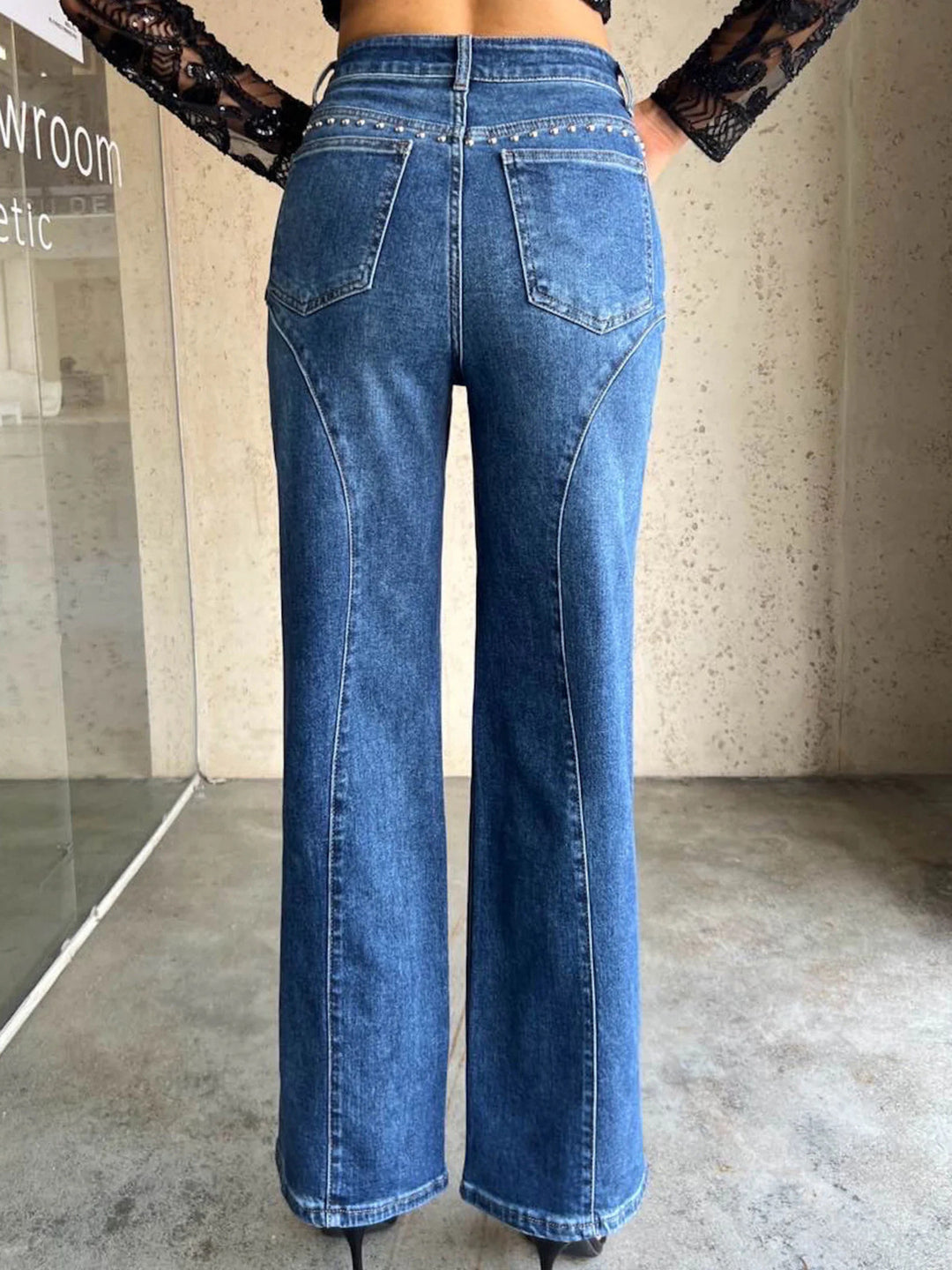 Studded high-rise wide-leg jeans with curved seam detail