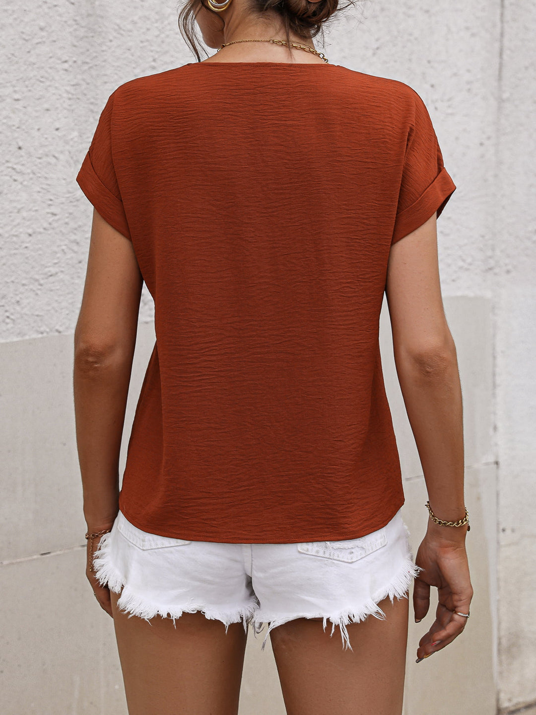 Buttoned V-neck short sleeve blouse with rolled cuffs