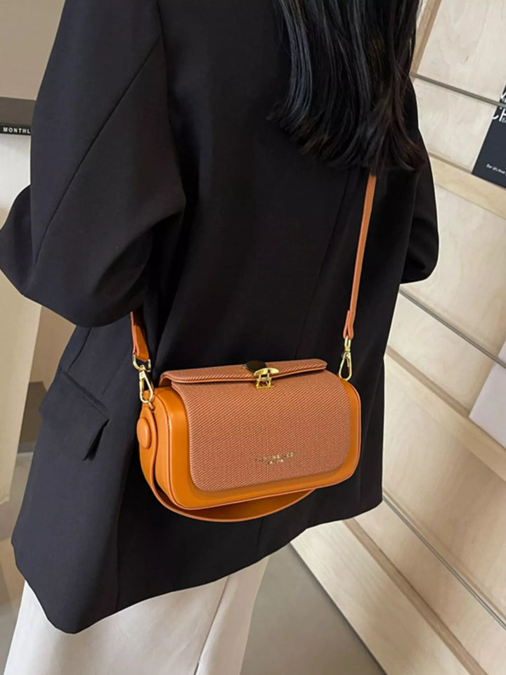 Structured boxy crossbody bag with gold clasp and top handle