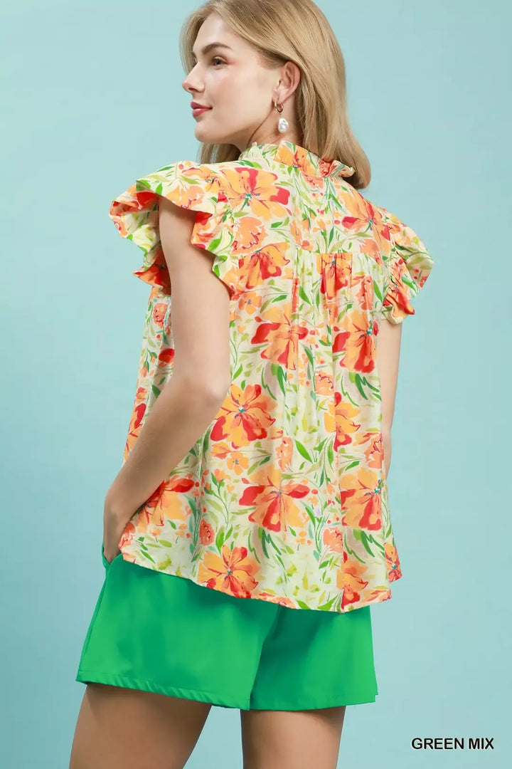 Smocked yoke flutter sleeve floral blouse with split V-neck