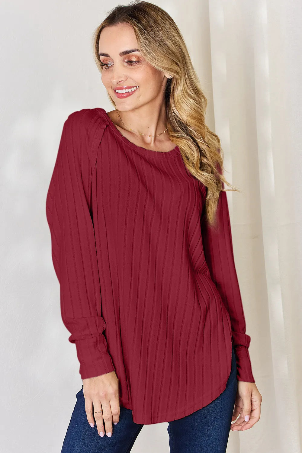 Ribbed knit round neck long sleeve top with side slits