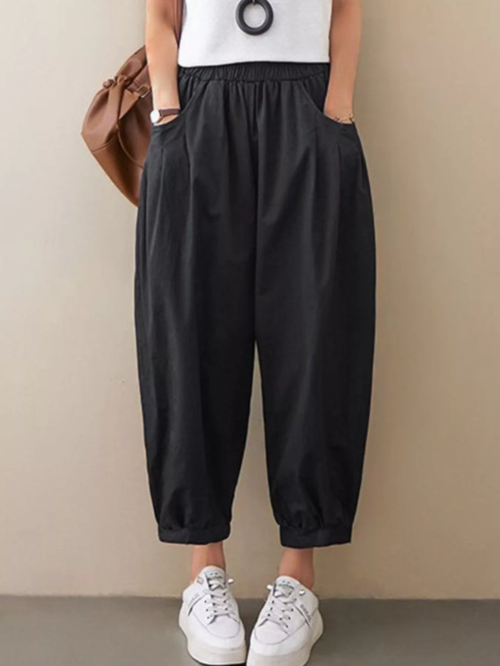 Pleated harem pants with elastic waist and tapered cuffs