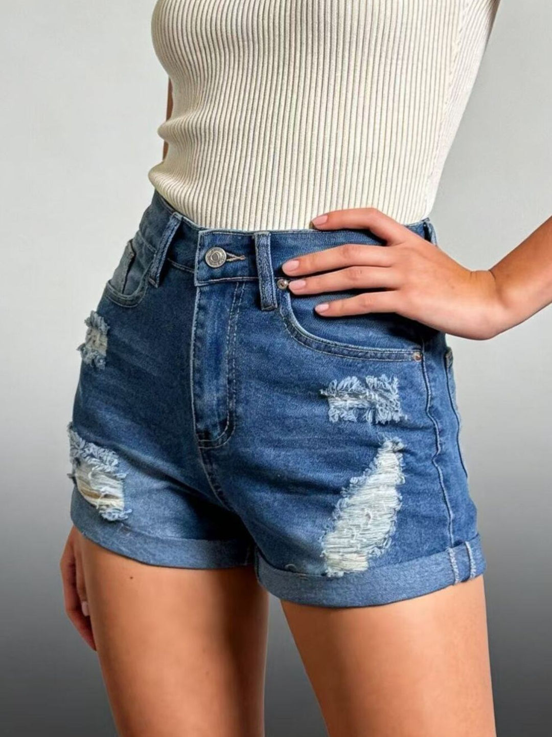 Distressed high-rise denim shorts with cuffed hem