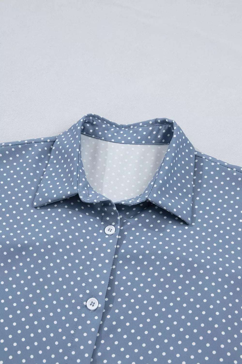 Polka dot button-down shirt with cuffed short sleeves
