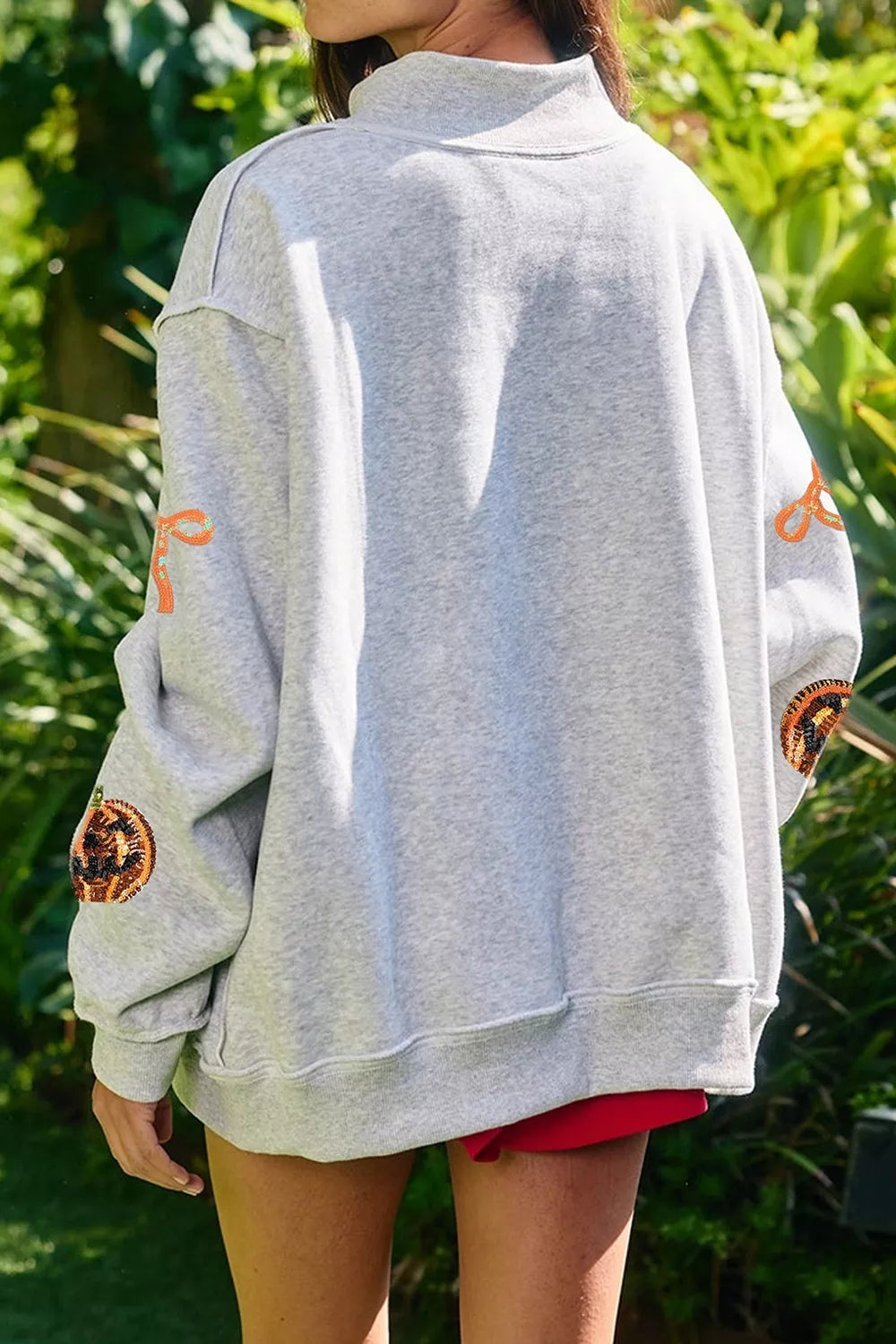 Sequin pumpkin and bow exposed seam Halloween sweatshirt