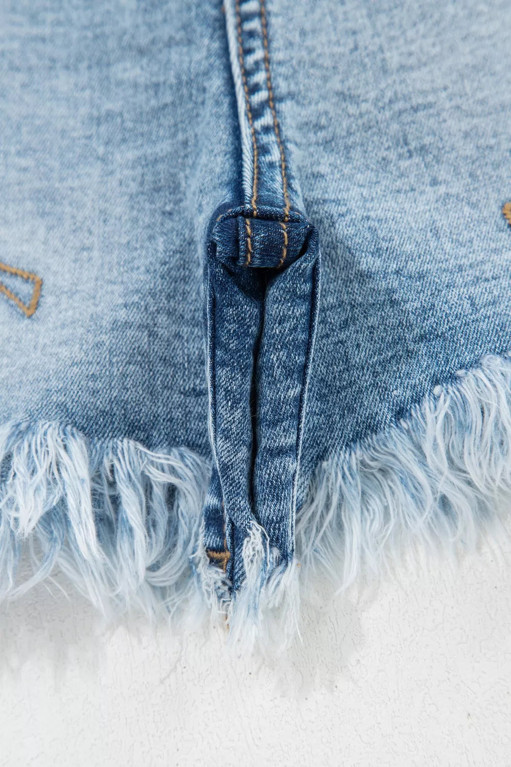 Western embroidered studded denim shorts with raw hem