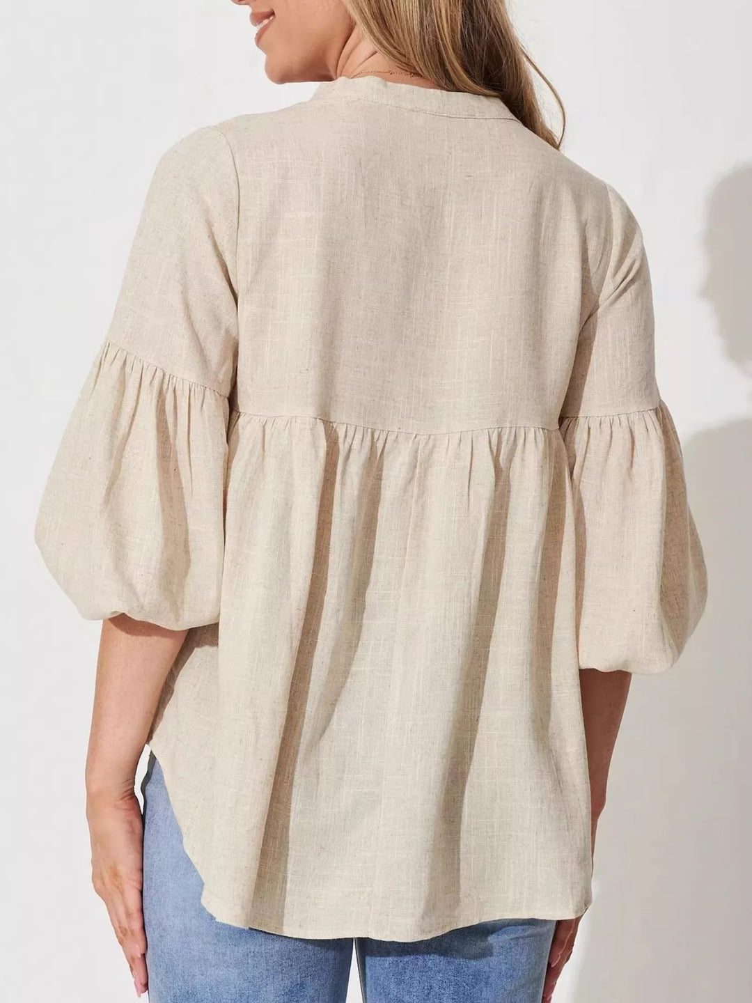Balloon sleeve blouse with notched neckline and high-low hem