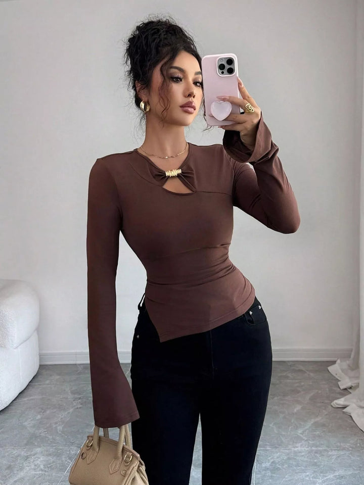 Cutout long sleeve top with gold ring and asymmetrical hem