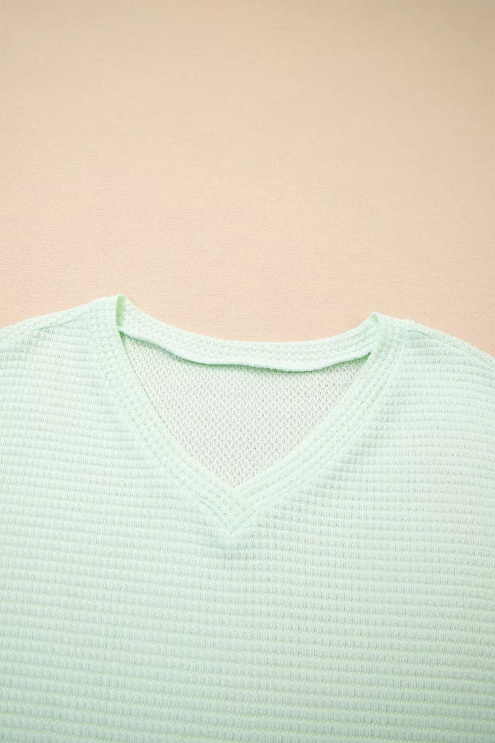Plus size waffle knit V-neck top with cuffed short sleeves