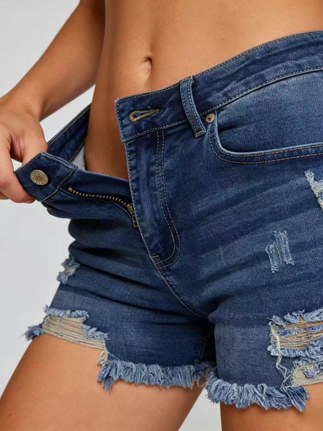 Distressed high-rise denim shorts with frayed raw hem