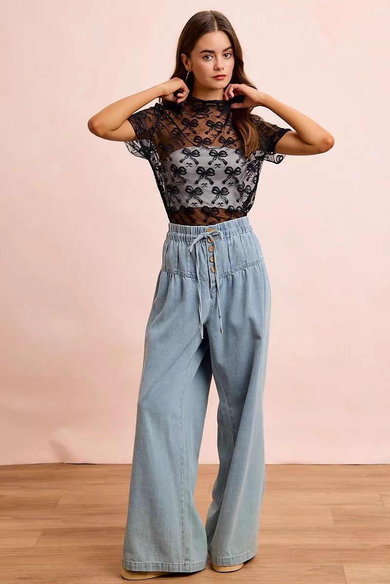 Sheer mesh mock-neck top with allover bow pattern
