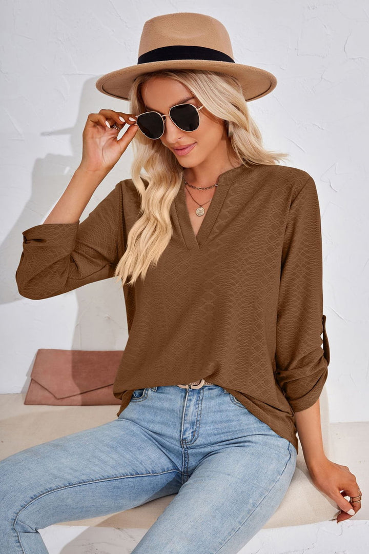 Textured split v-neck blouse with roll-tab sleeves