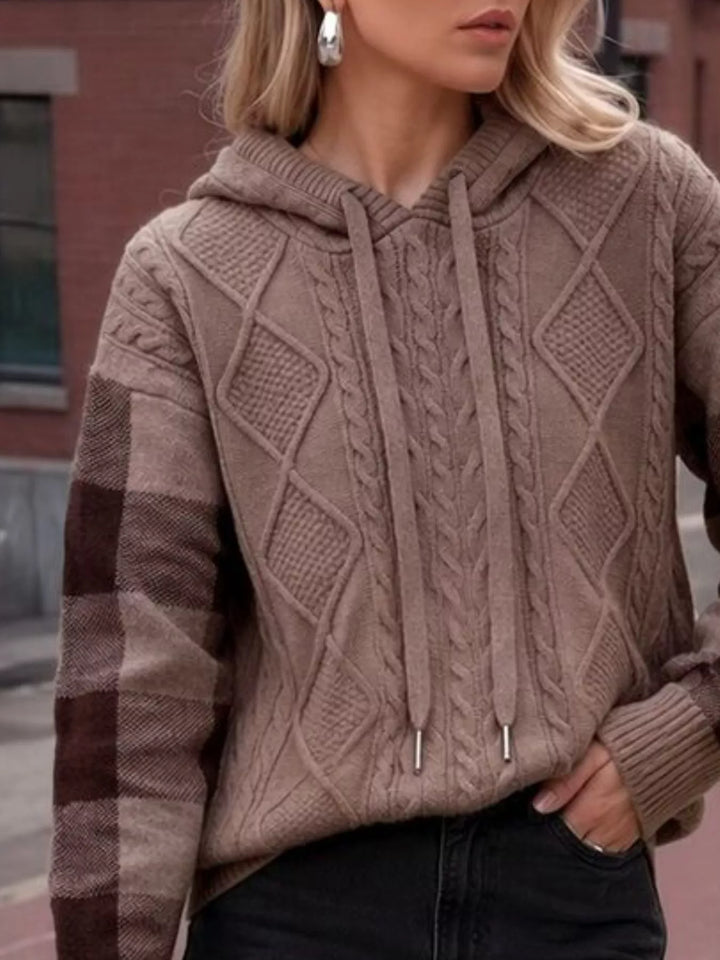 Cable knit hooded sweater with plaid sleeves and drawstring
