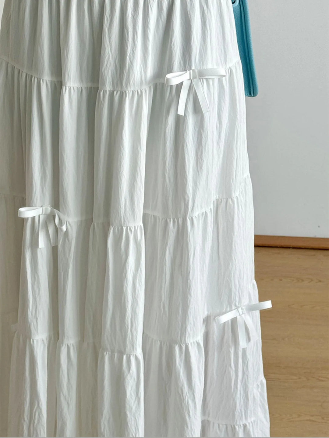 Tiered bow-accent maxi skirt with elastic smocked waist
