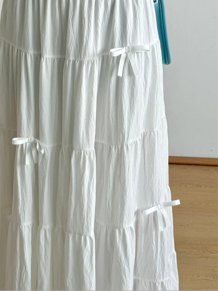 Tiered bow-accent maxi skirt with elastic smocked waist