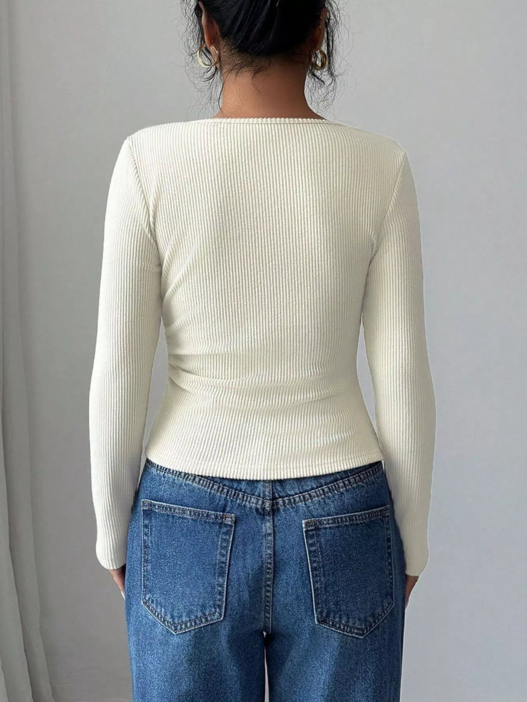 Ribbed knit asymmetric neckline top with gold buckle twist